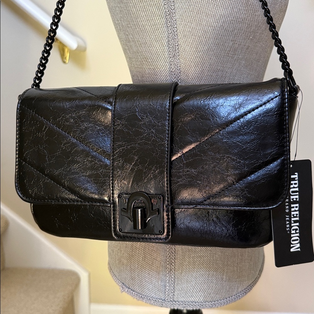 True Religion black faux leather handbag.  Metallic snap closure.